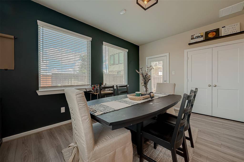 Step into this inviting family room/loft on the first floor of a stunning three-story home. Bathed in natural light from large windows with backyard views, the open-concept design seamlessly connects indoor and outdoor spaces. Elegant flooring, no carpet, and a versatile layout make it perfect for gatherings.