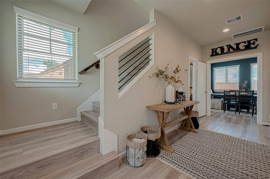 Explore the spacious hallways and stairways connecting all three floors of this home, featuring 2.5 bathrooms. The wide, well-lit corridors provide easy access and a sense of openness, enhancing the home's flow and accessibility.