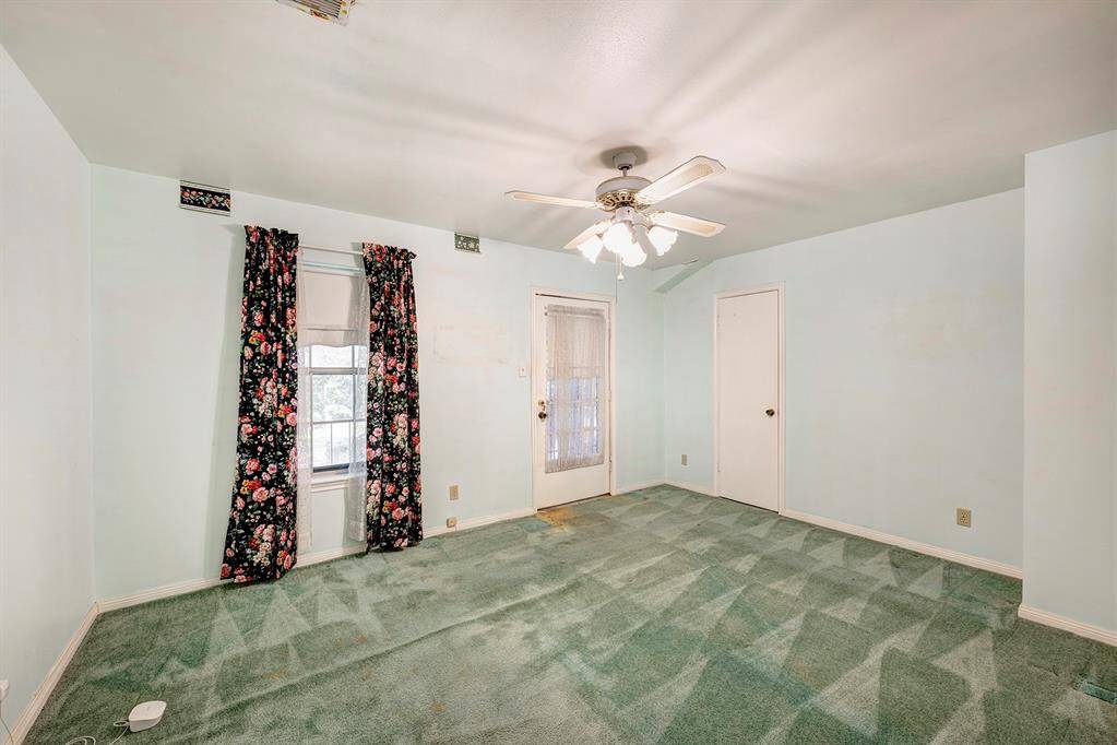 First of the upstairs secondary bedrooms. All are a good size. This bedroom has access to a covered balcony overlooking the front yard.