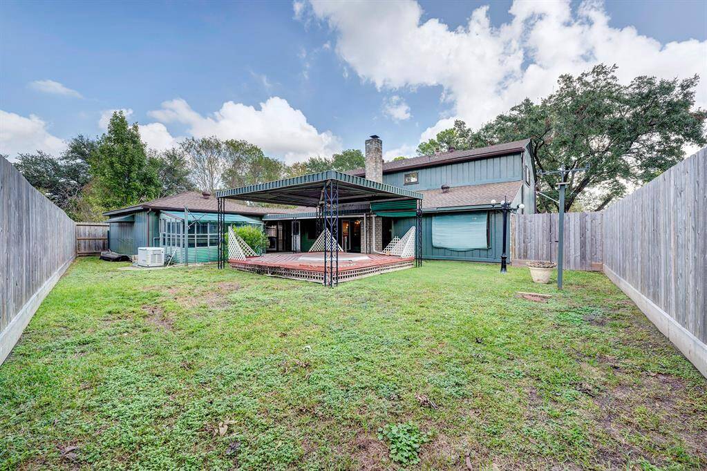 Fenced backyard (installed in 2022) with covered deck.