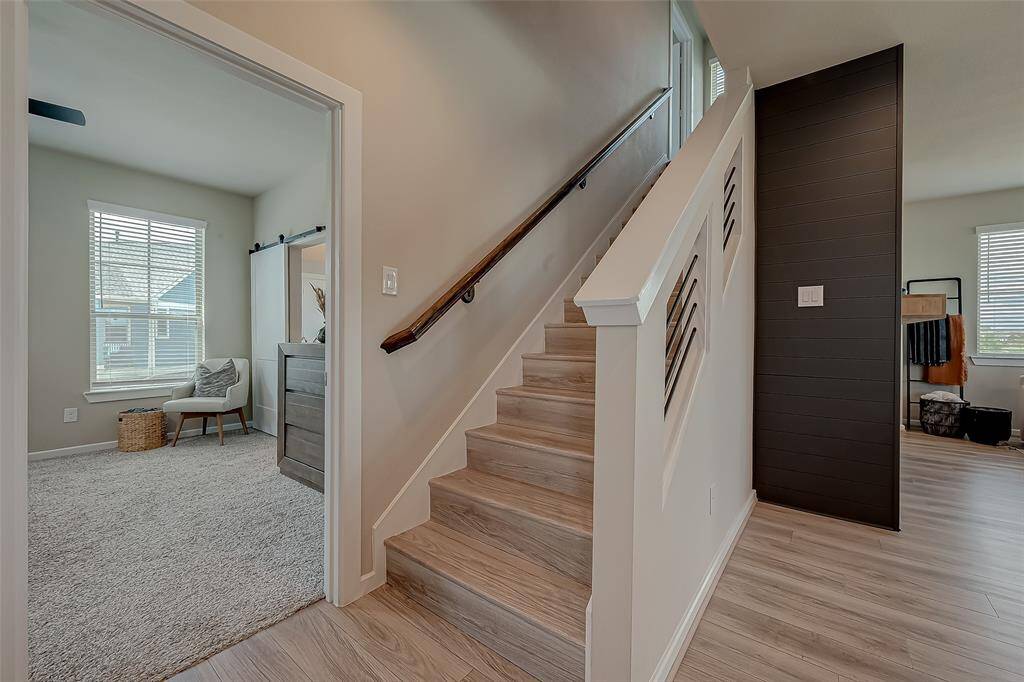 Explore the spacious hallways and stairways connecting all three floors of this home, featuring 2.5 bathrooms. The wide, well-lit corridors provide easy access and a sense of openness, enhancing the home's flow and accessibility.