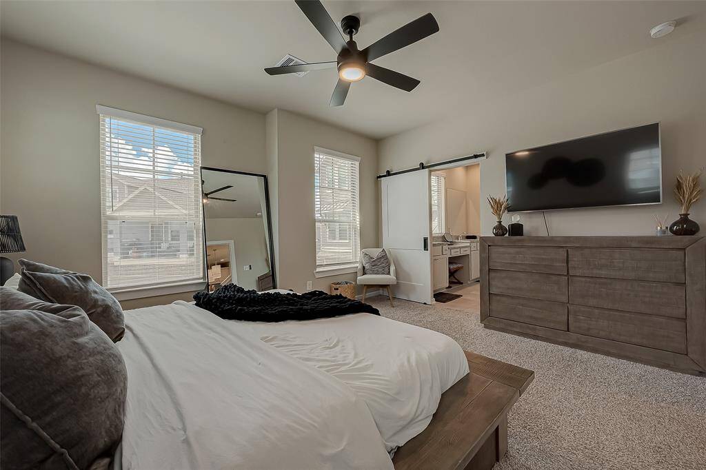 The spacious primary bedroom suite is flooded with natural light, creating a bright and airy atmosphere. With ample room, it offers a comfortable and inviting retreat, perfect for relaxation and personal enjoyment.