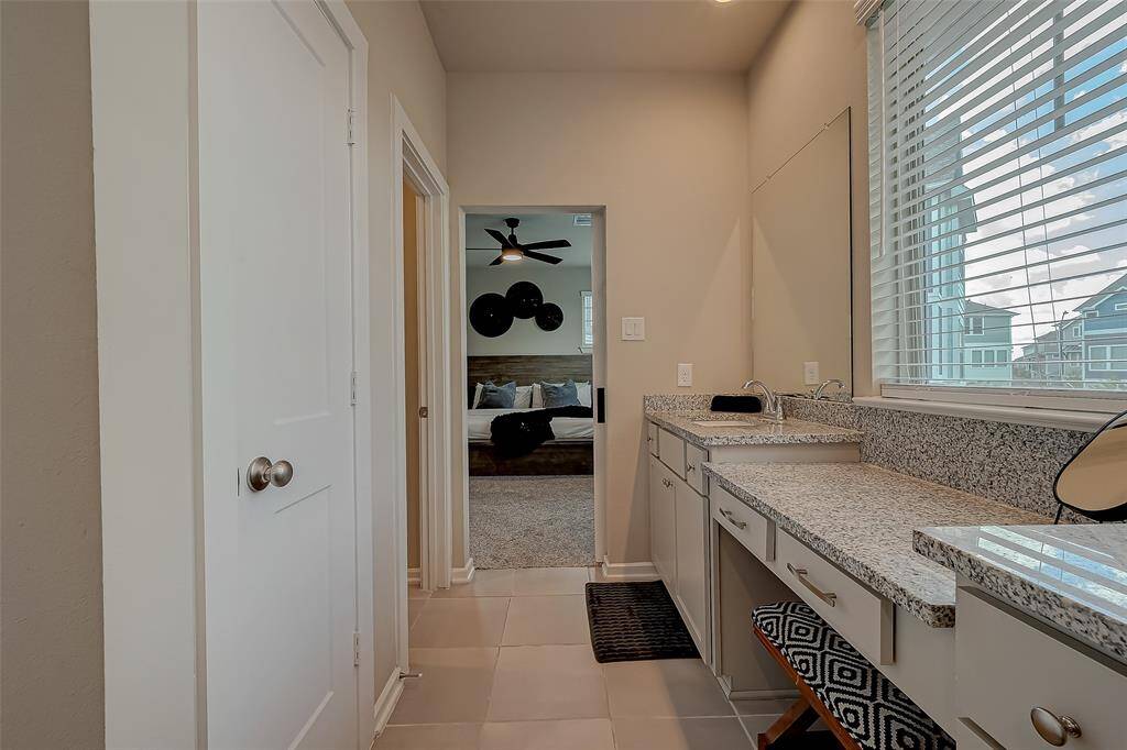 The full-size primary ensuite features a spacious shower, double sinks, and ample closet space. This luxurious bathroom offers modern amenities and elegant design, providing a perfect retreat for relaxation and convenience.