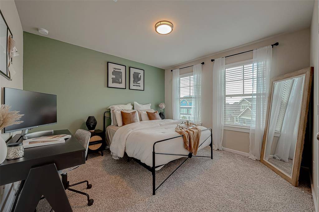 The second bedroom is generously sized and filled with natural light, creating a bright and inviting space. Its ample room offers flexibility for various uses, making it a comfortable and functional area for guests or family members.