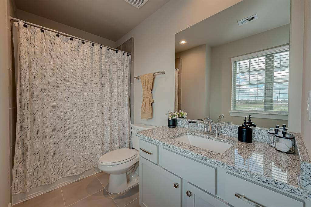 This secondary bathroom on the third floor is conveniently situated near the 2nd and 3rd bedrooms. It features a tub/shower combo, combining functionality with comfort for easy access and everyday use.