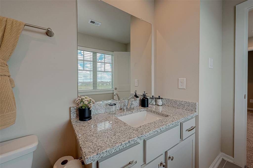 This secondary bathroom on the third floor is conveniently situated near the 2nd and 3rd bedrooms. It features a tub/shower combo, combining functionality with comfort for easy access and everyday use.