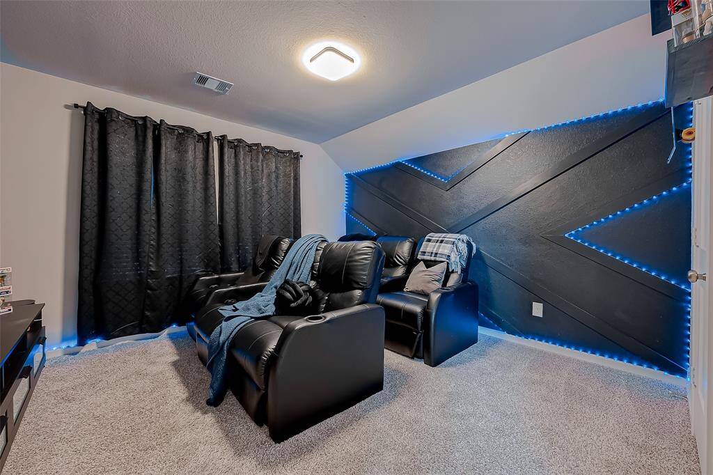 The third floor features a versatile bedroom/media room, offering spaciousness and ample natural light. This flexible area can serve as a cozy retreat or an entertainment hub, making it perfect for both relaxation and media enjoyment.