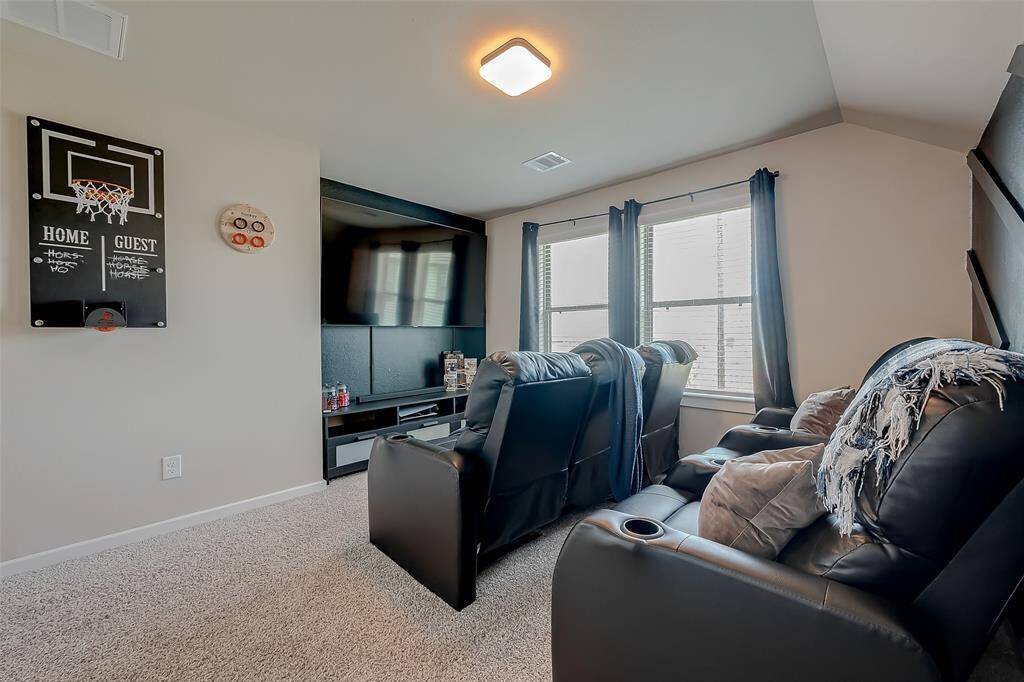 The third floor features a versatile bedroom/media room, offering spaciousness and ample natural light. This flexible area can serve as a cozy retreat or an entertainment hub, making it perfect for both relaxation and media enjoyment.
