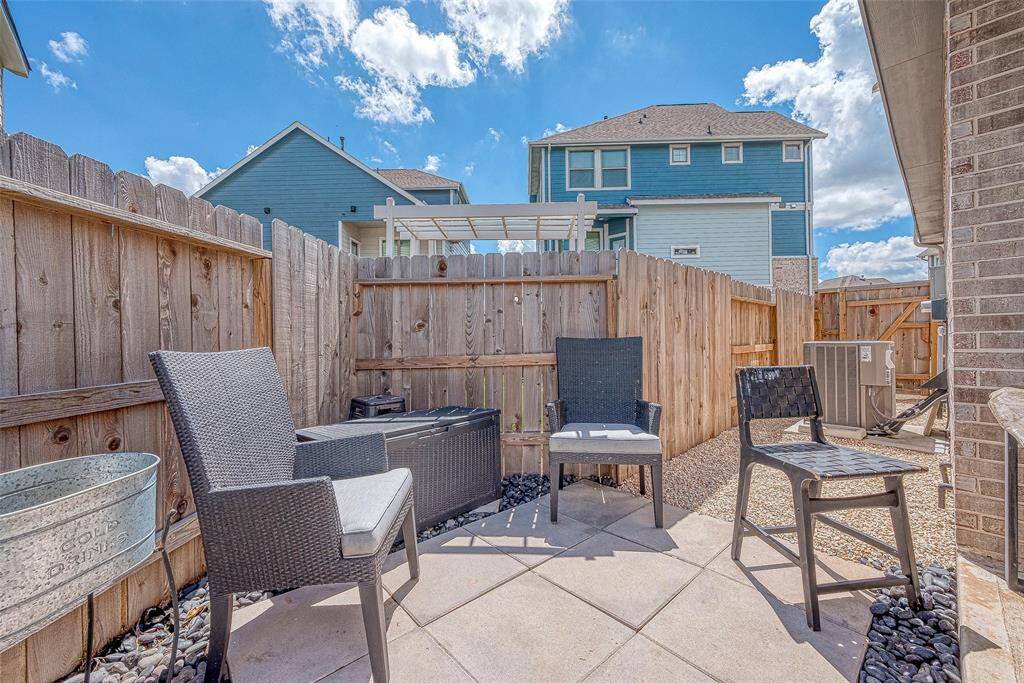 Enjoy a nice-sized backyard featuring a custom covered patio area, perfect for outdoor dining and relaxation. This inviting space offers ample room for activities and gatherings, making it an ideal spot for entertaining and enjoying the outdoors.