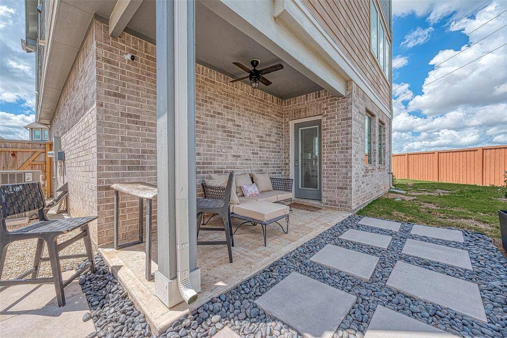 Enjoy a nice-sized backyard featuring a custom covered patio area, perfect for outdoor dining and relaxation. This inviting space offers ample room for activities and gatherings, making it an ideal spot for entertaining and enjoying the outdoors.