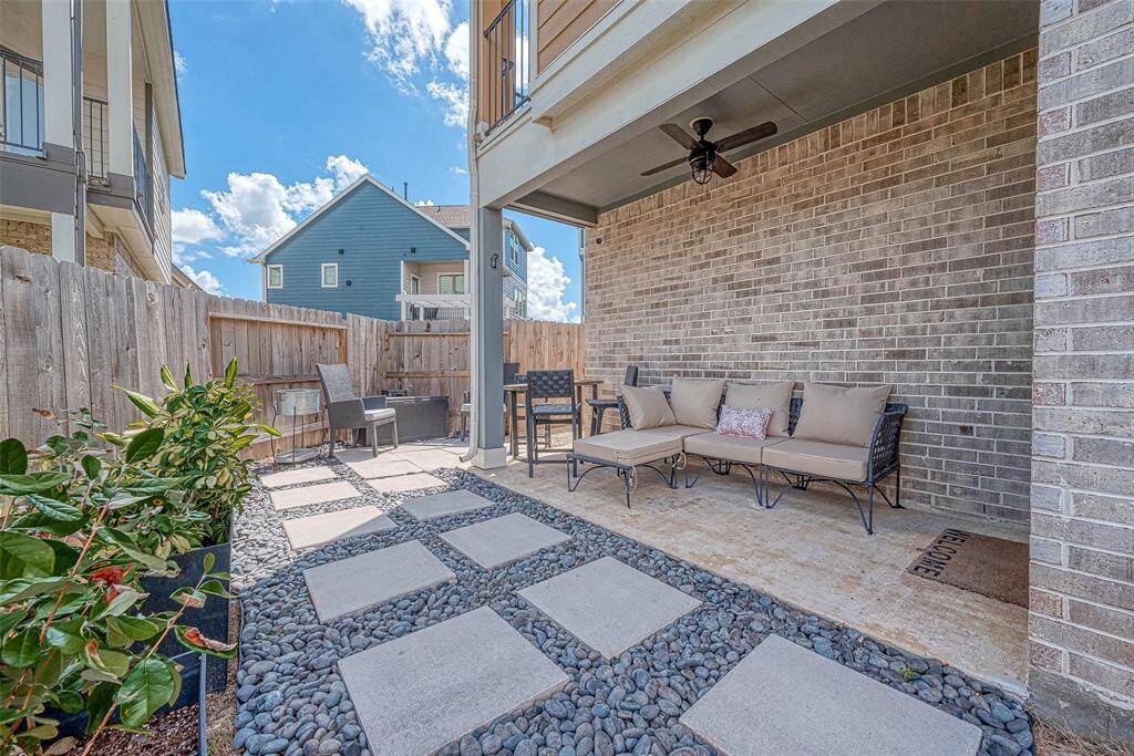 Enjoy a nice-sized backyard featuring a custom covered patio area, perfect for outdoor dining and relaxation. This inviting space offers ample room for activities and gatherings, making it an ideal spot for entertaining and enjoying the outdoors.