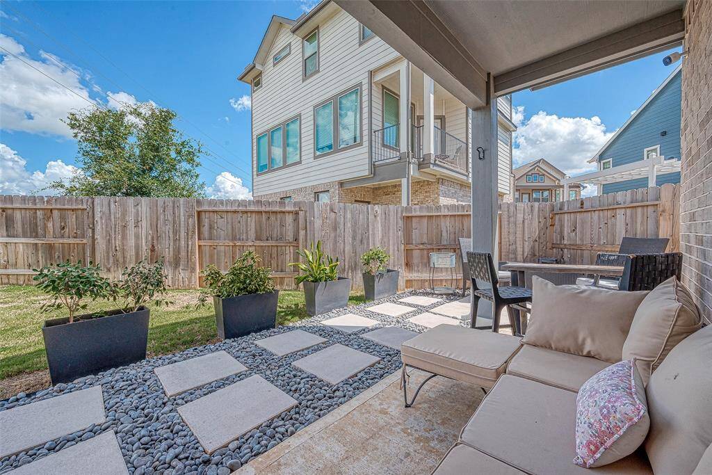 Enjoy a nice-sized backyard featuring a custom covered patio area, perfect for outdoor dining and relaxation. This inviting space offers ample room for activities and gatherings, making it an ideal spot for entertaining and enjoying the outdoors.