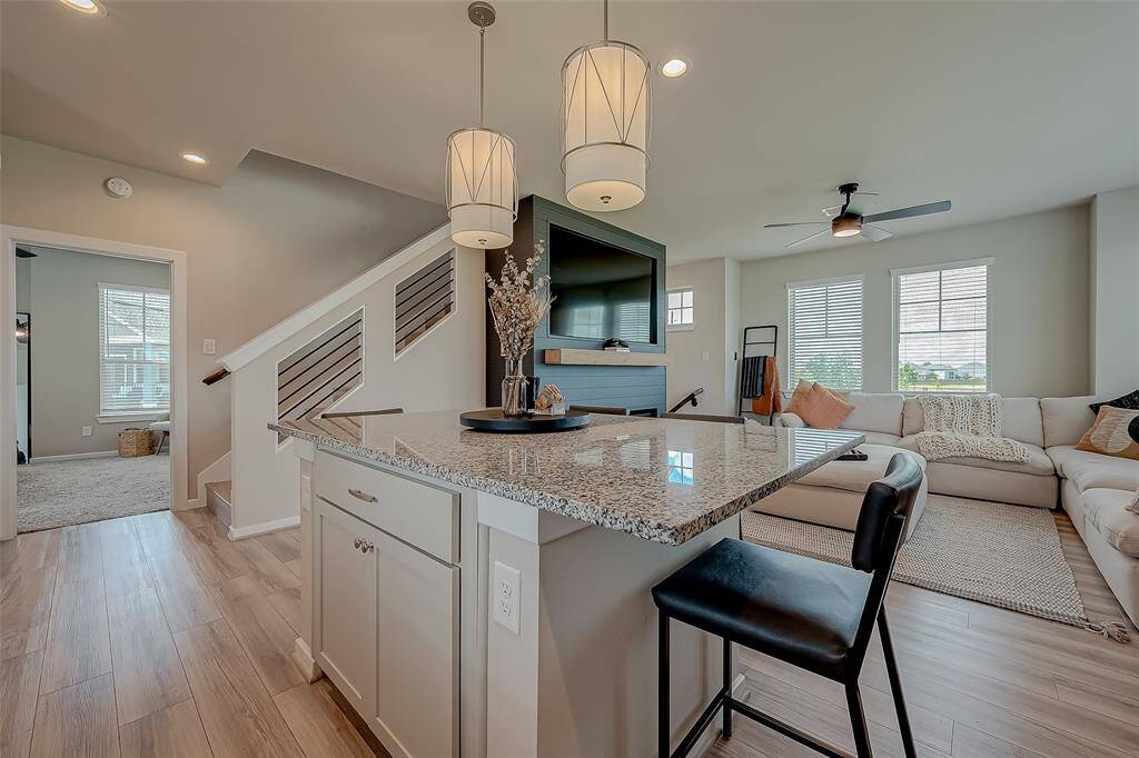 Discover the updated kitchen, featuring modern appliances, ample lighting, and an oversized island. This stylish and functional space is perfect for cooking and entertaining, offering a contemporary design that enhances the heart of the home.