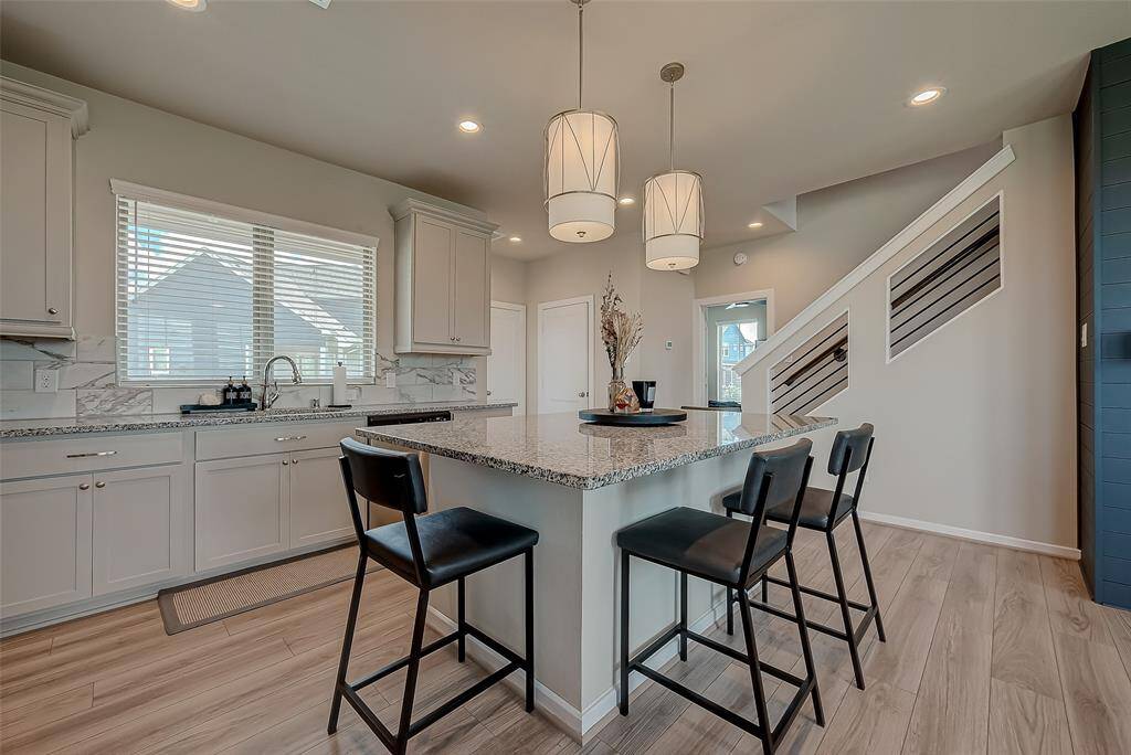 Discover the updated kitchen, featuring modern appliances, ample lighting, and an oversized island. This stylish and functional space is perfect for cooking and entertaining, offering a contemporary design that enhances the heart of the home.