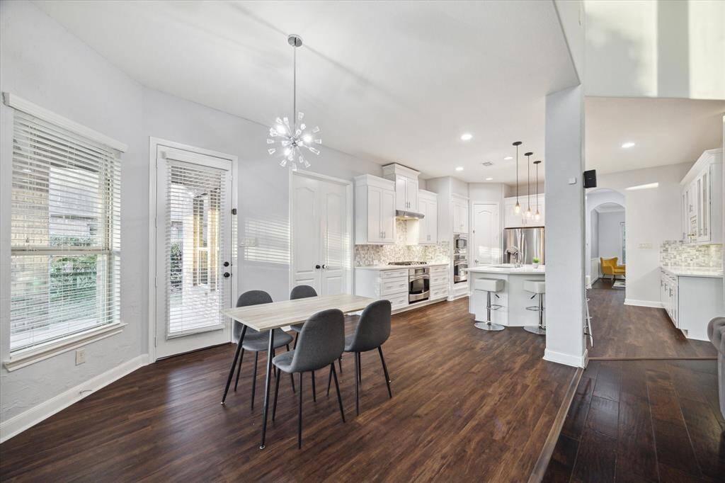 Another view highlights the seamless flow between the kitchen and dining areas, offering an open and inviting space perfect for entertaining. The convenience of the back door leading directly to the backyard makes it easy to transition from indoor cooking to outdoor relaxation or dining, enhancing the functionality of this beautiful home.