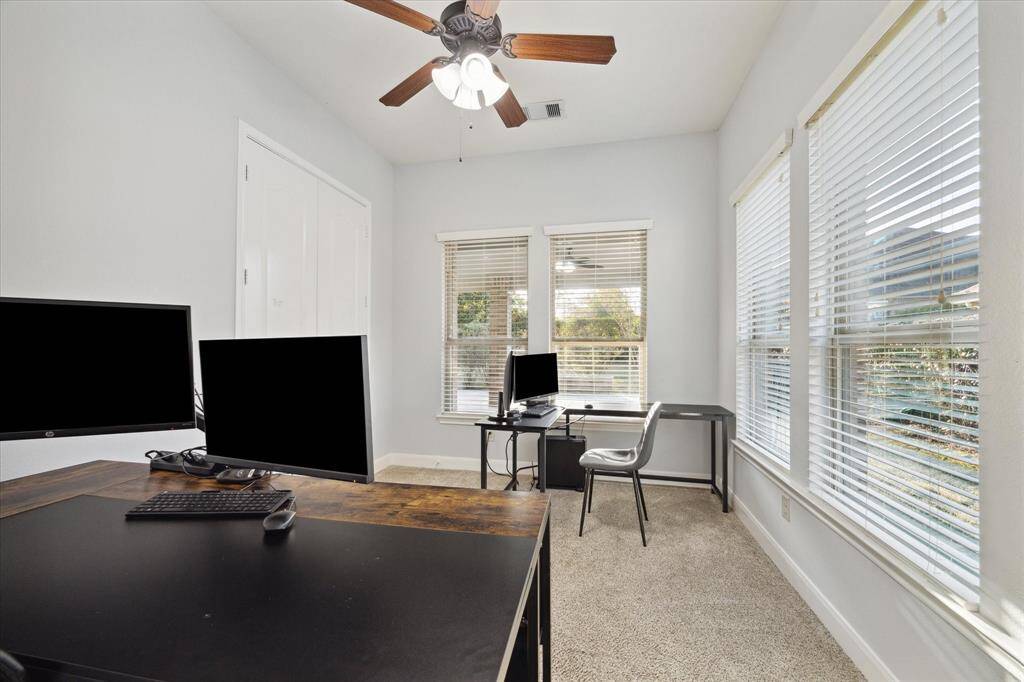 Flex room off the kitchen offers endless possibilities, currently being used as an extra home office space.