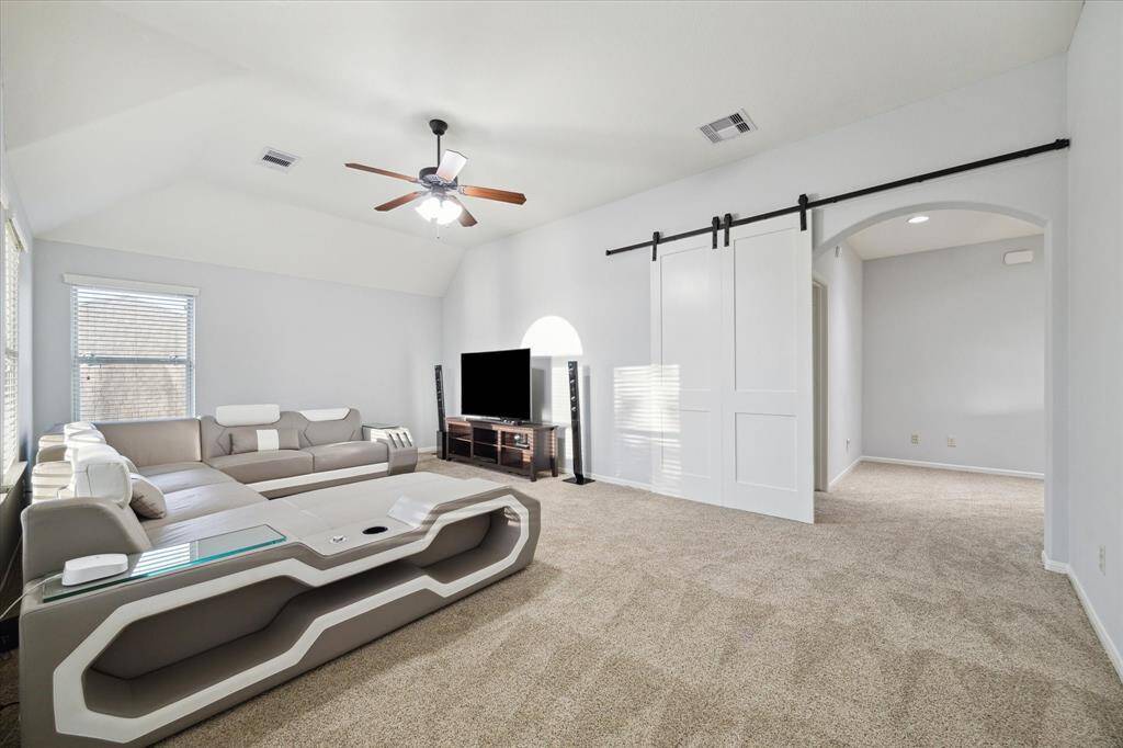While upstairs, step into the gameroom, enclosed by stylish sliding barn doors. With plush carpeting underfoot and ample room for kids to play or relax, this versatile space is perfect for family movie nights, gaming, or gathering with friends.