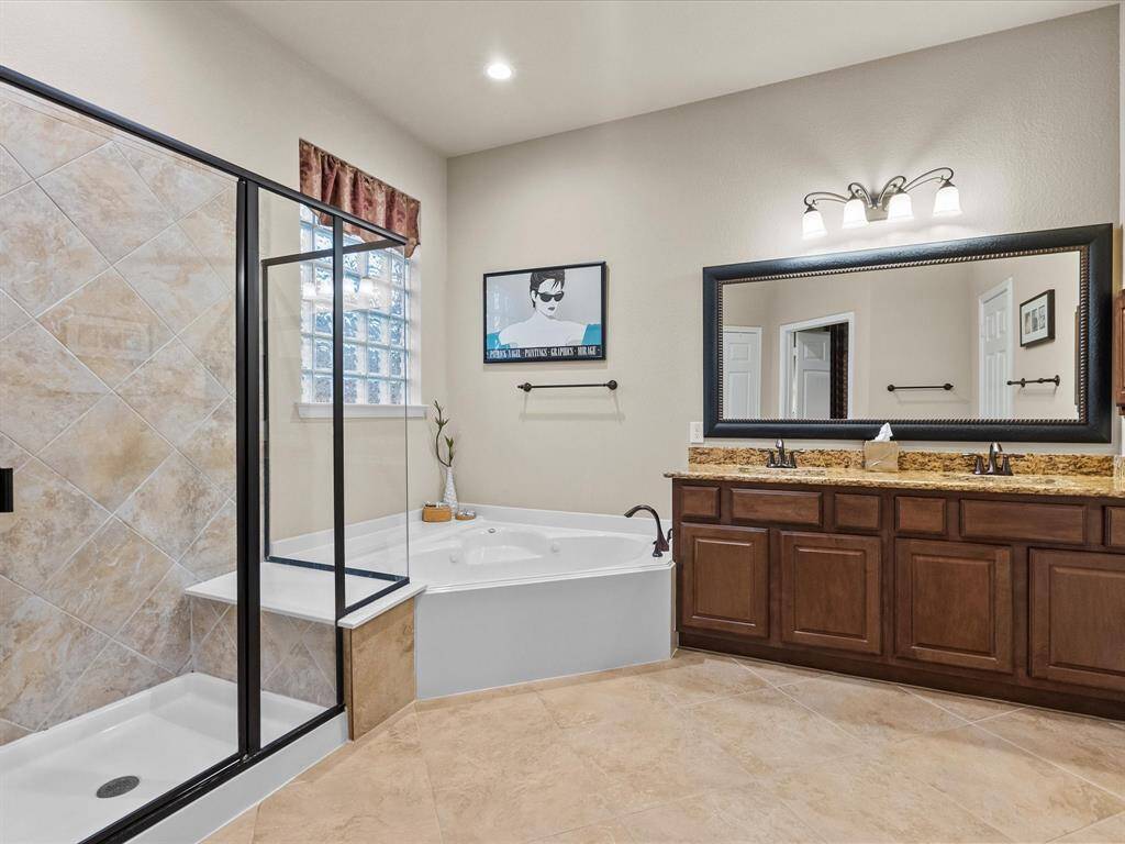 Large Primary Bath Features Large Walk In Shower and Whirlpool Tub.