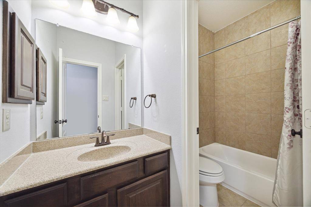 Secondary full bathroom located off the hallway upstairs, convenient for family and guests alike.