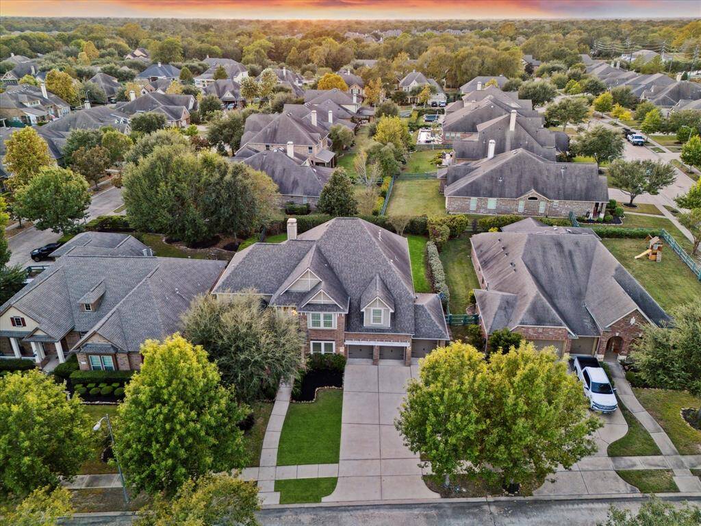 Take in this aerial view, offering a stunning bird's-eye perspective of the home and its surrounding property. This unique vantage point beautifully highlights the layout.