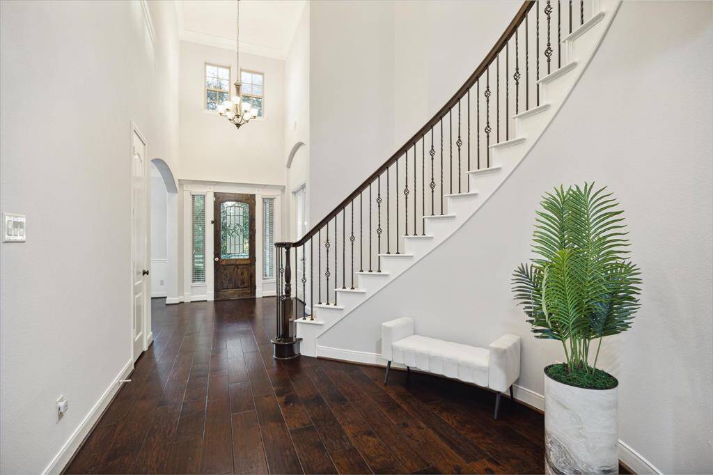 As you enter, you will be greeted by the soaring two-story ceiling that is sure to make you fall in love.The grand staircase invites you to explore the upstairs haven, setting the tone for the elegance and spaciousness found throughout this home.