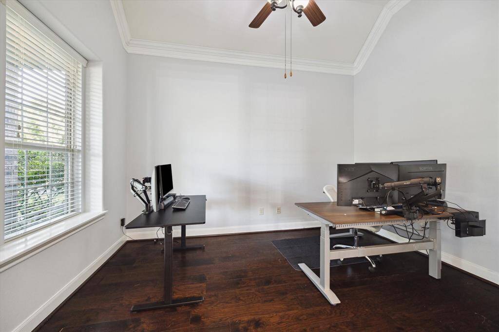 Located at the front of the home, you'll find a private office enclosed behind glass french doors with a large window that floods the room with natural sunlight, creating a bright and inviting workspace.