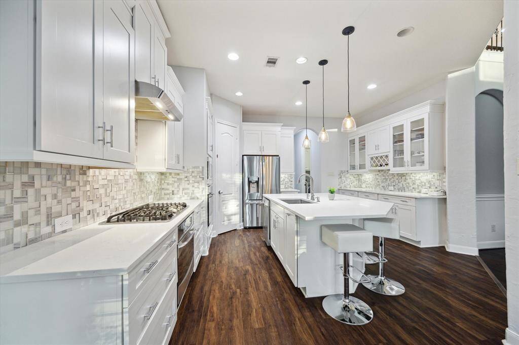 Step into this gorgeous chef's kitchen, designed to make the most of your culinary skills. With top-of-the-line appliances and plenty of counter space, it’s the perfect setting to create your next masterpiece.