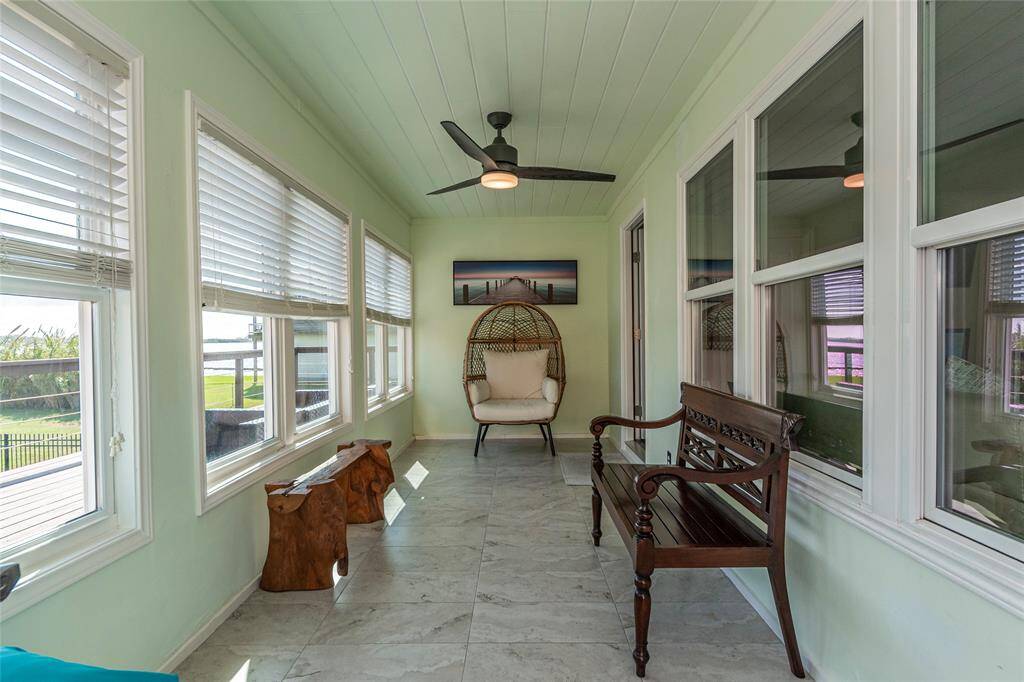 Spacious sunroom with panoramic bay views—perfect for enjoying the scenery in any weather!