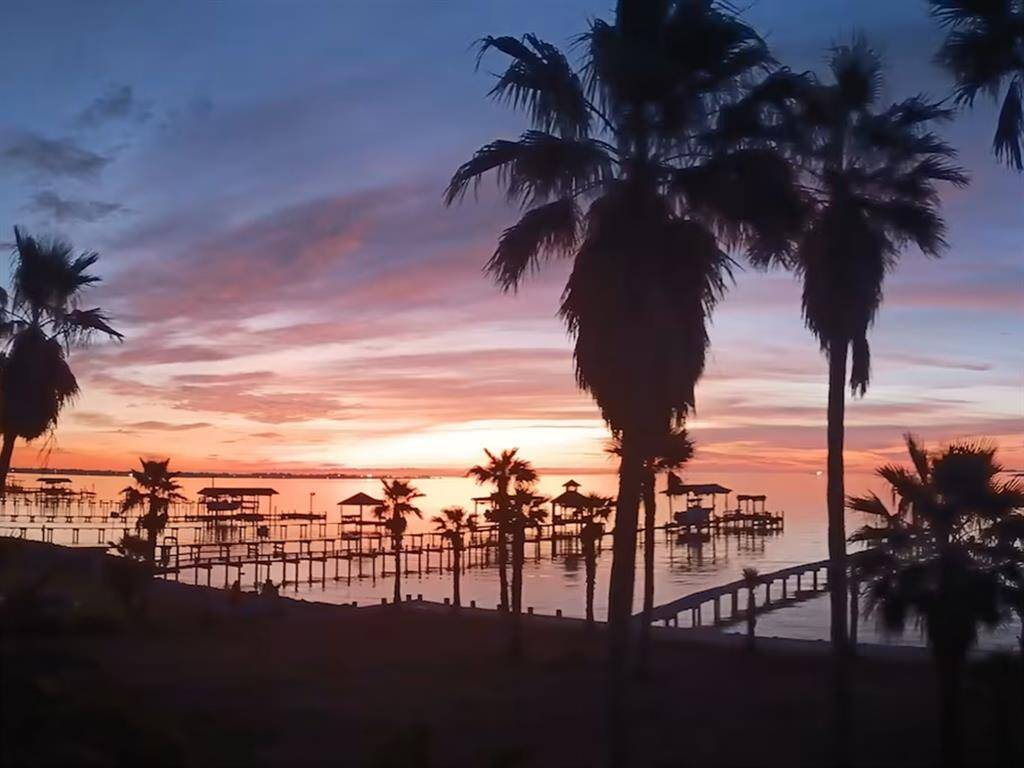 Grab your coffee and soak in the beauty of the morning sunrise over Galveston Bay.