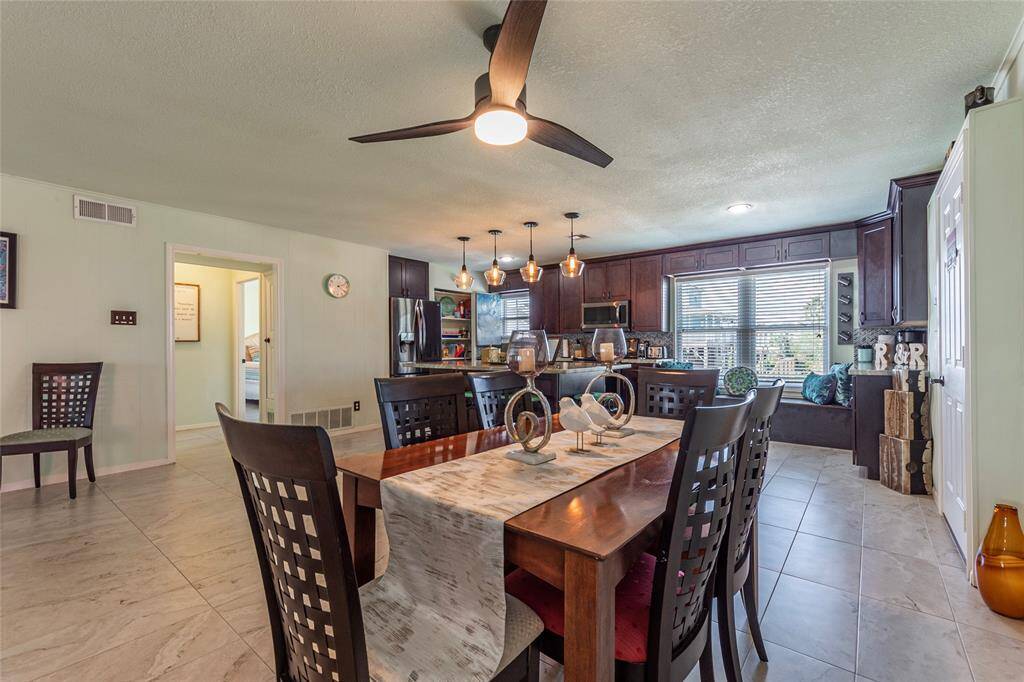 The spacious dining area easily accommodates a six-person table, offering plenty of room for family meals and entertaining guests.