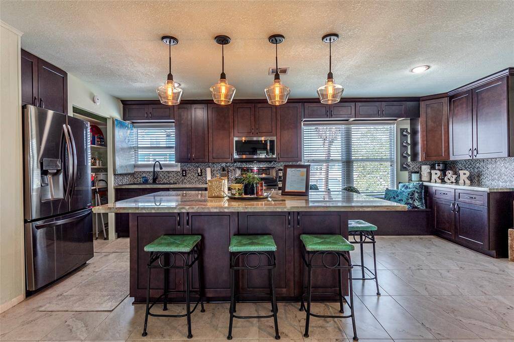 The expansive kitchen and oversized island offer plenty of room to prepare your favorite dishes, making it a chef's dream for cooking and entertaining.