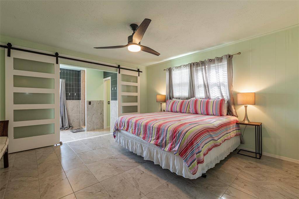 Step into the spacious primary suite, thoughtfully designed with ample room for a cozy reading nook, where you can unwind in your private retreat. Stylish barn doors lead into the luxurious ensuite