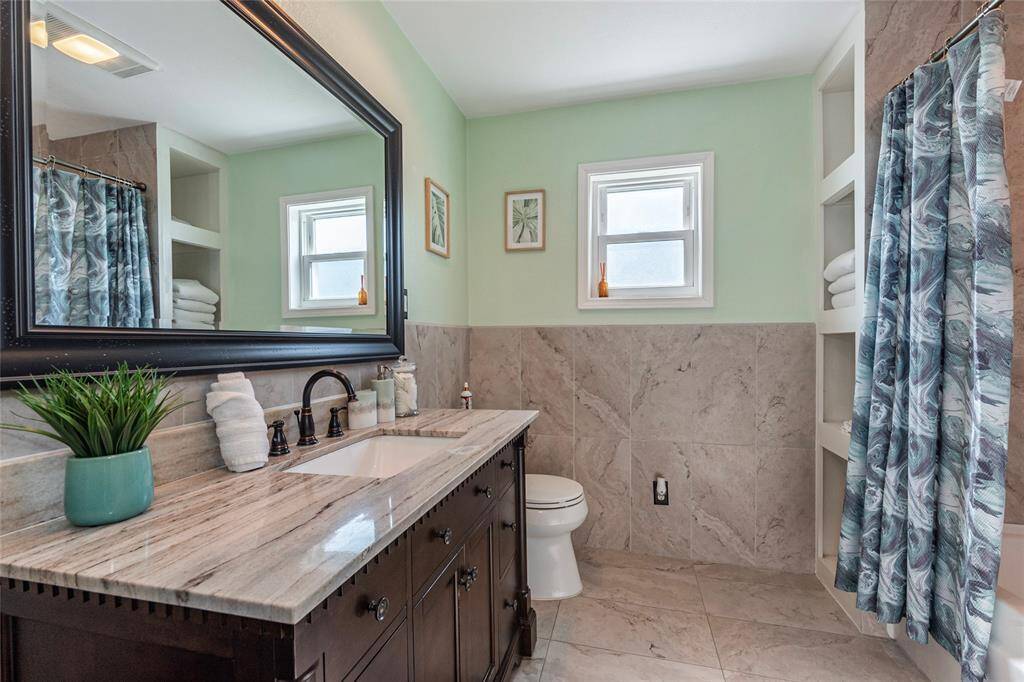 The generously sized guest bathroom features plenty of space, offering both comfort and functionality.