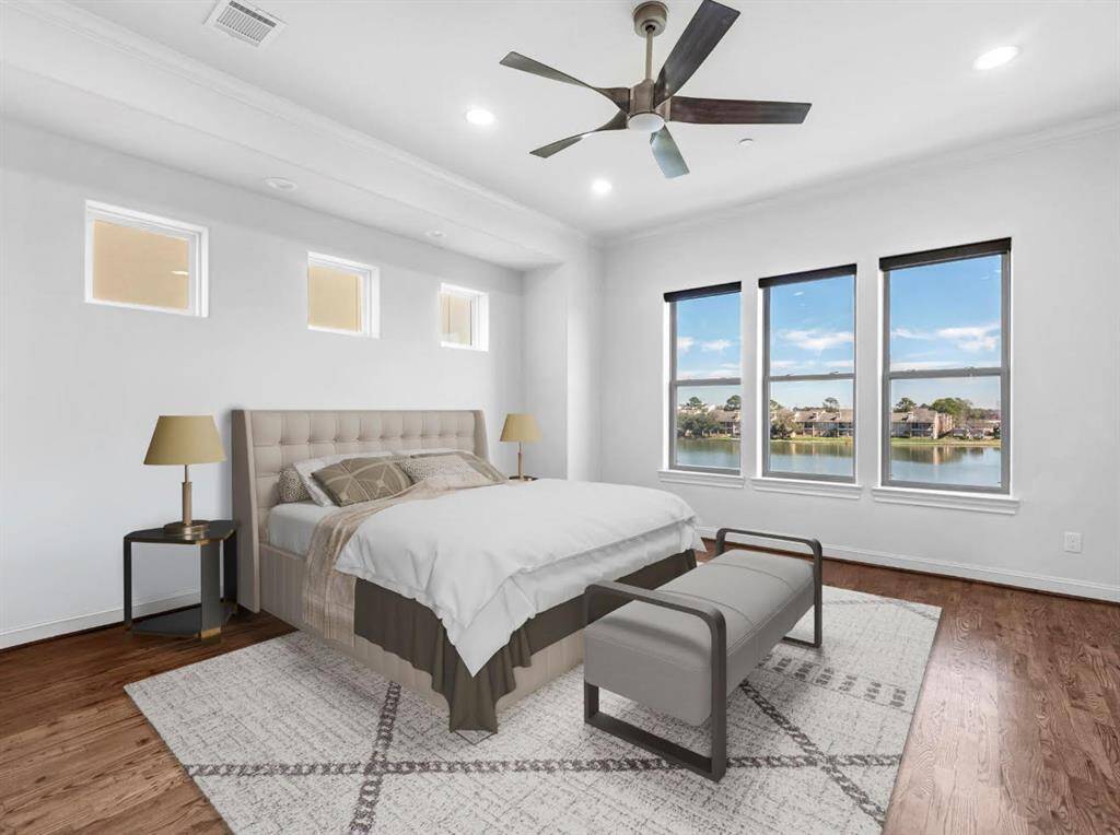 Virtually staged to display a design concept in the primary bedroom, offering stunning lake views.