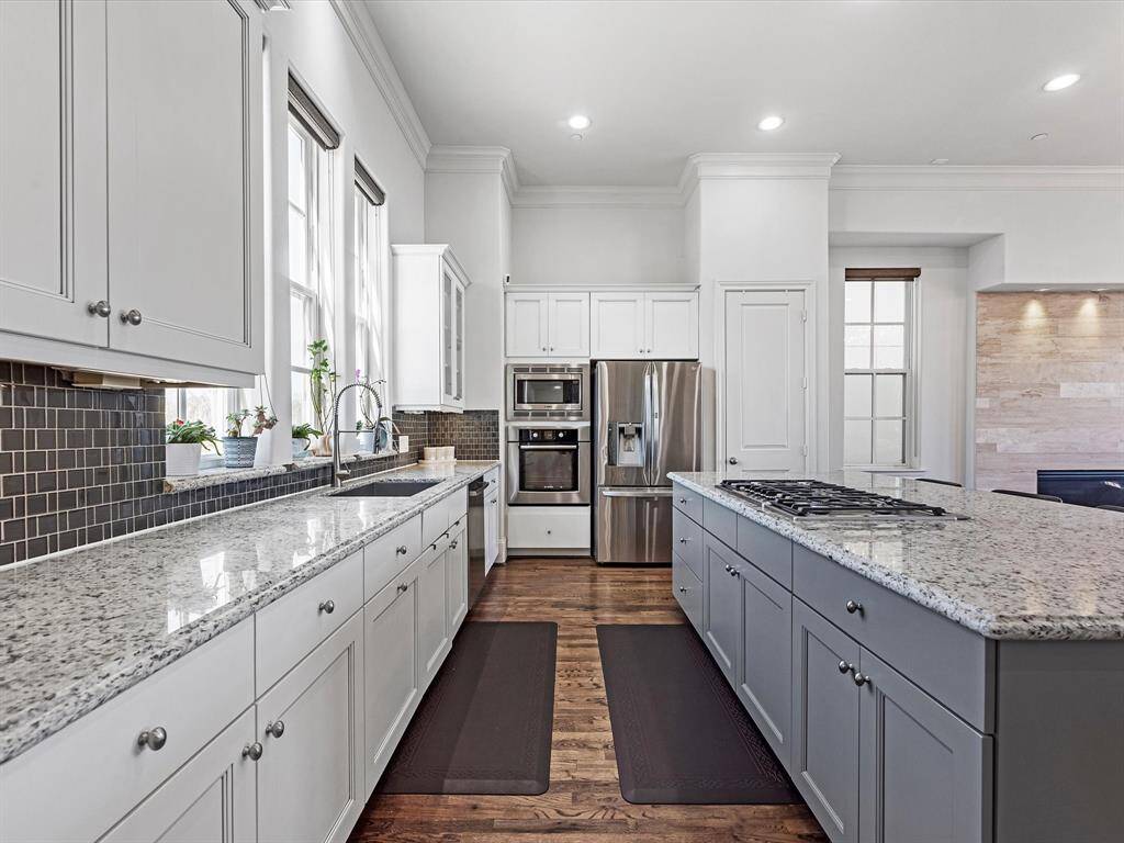 The Chef's dream kitchen is fully equipped with high end Bosch Appliances, 5 Burner stove top with downdraft, Granite counters, Farmhouse Sink, Upgraded faucets, Upgraded disposal, Trash cabinet, all cabinets with handles - this Kitchen has it all!!!