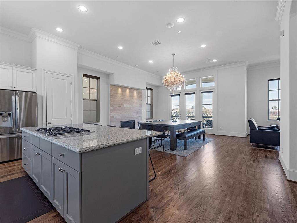 The dining area features a beautifully upgraded fireplace with art lighting and ample space for a 12+ seat table (as shown)—a true entertainer’s dream!
