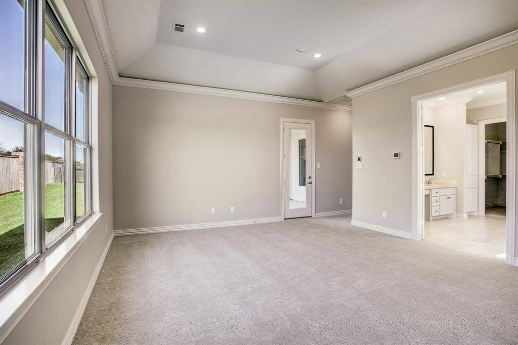 Downstairs - Guest bedroom with wood flooring and walk-in closet with private bathroom.