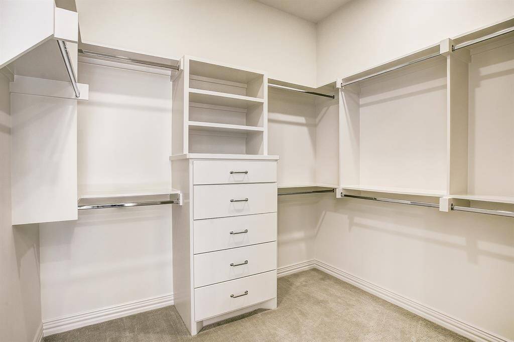 Large utility room downstairs with sink and plenty of cabinet space.