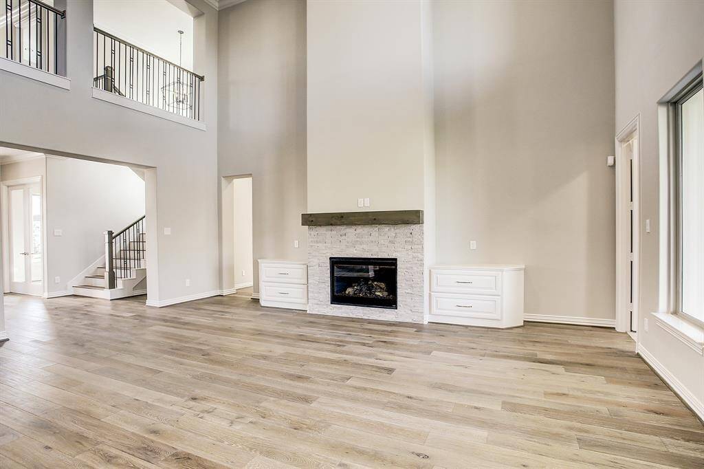 Large family room with wall of windows and overlooking the super size yard.