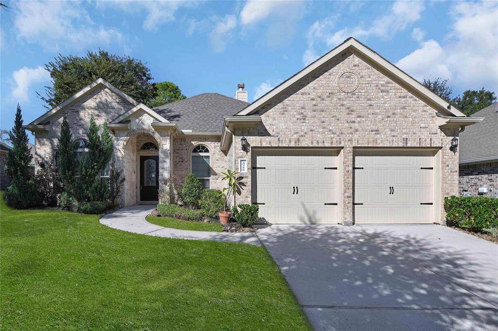 This charming brick home features a two-car garage, a well-maintained front yard, and a welcoming arched entryway. Ideal for those seeking a cozy and inviting exterior.