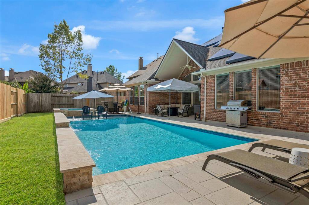 Just put in last year.  It's saltwater, 36' x 16' (576 sq ft), heated, tanning ledge, raised seat under natural stone waterfalls, AND a 7' Raised hot tub with full bench.  Faces East so stays cooler in the summer although it is plumber for a chiller if you like...Cost was 80K