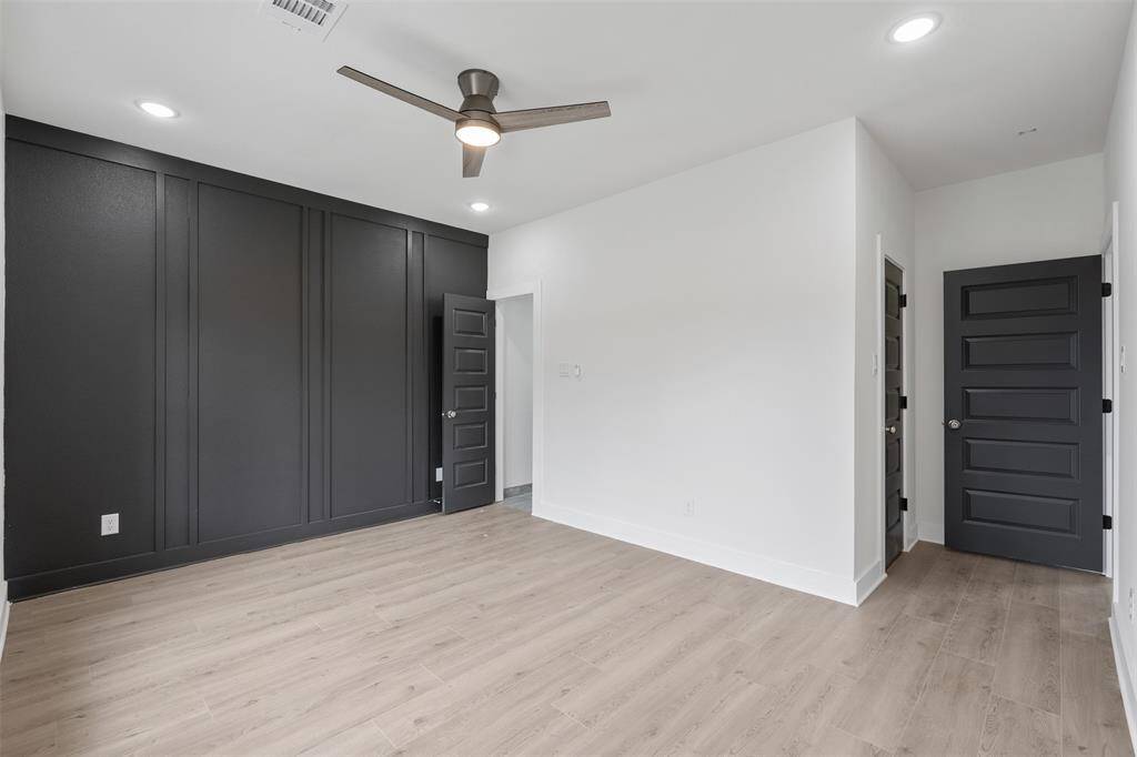 Primary bedroom with accent wall that adds visual depth and personal style without overwhelming the space.*photos are from builders previous model home with same layout and fixtures*