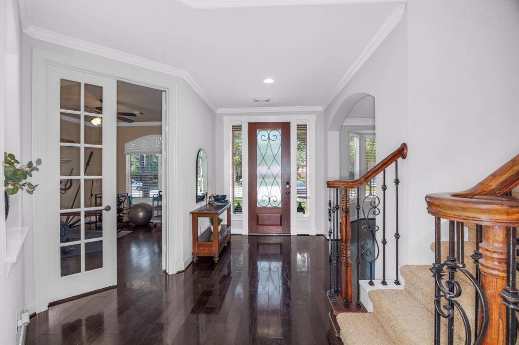 Notice the welcoming entry and hardwood floors. To the right coming in is the office and to the left is the spacious formal dining room