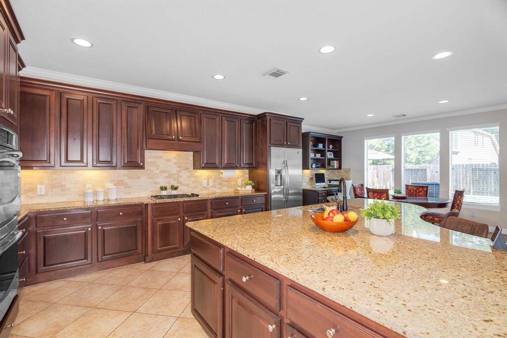 Just look at the abundance of counter and cabinet space combined with the double oven, 5 burner gas stove, and built-in desk.  Refrigerator in the kitchen stays with the house.