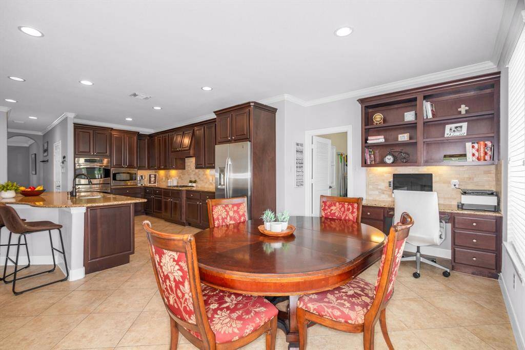 Bar seating and breakfast area means plenty of space for everyone.  The door shown is to the spacious utility room with built-in counter and cabinets.
