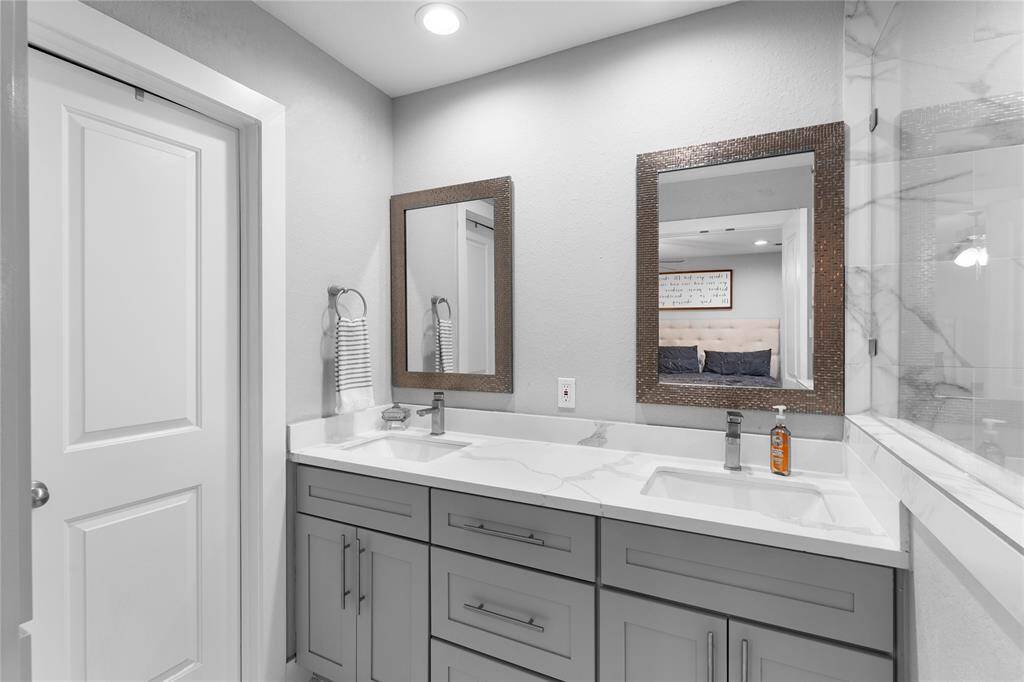 Updated with dual sinks, framed mirrors, and modern fixtures.