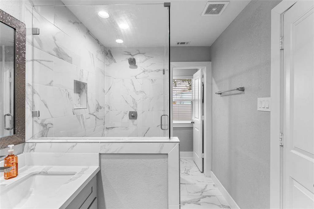 Spacious walk-in shower with frameless glass.