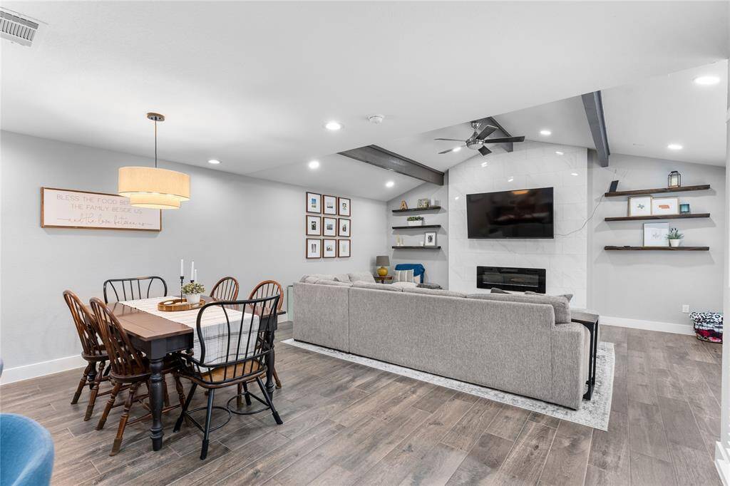 Spacious with vaulted ceilings, wood-look flooring, and recessed lighting.