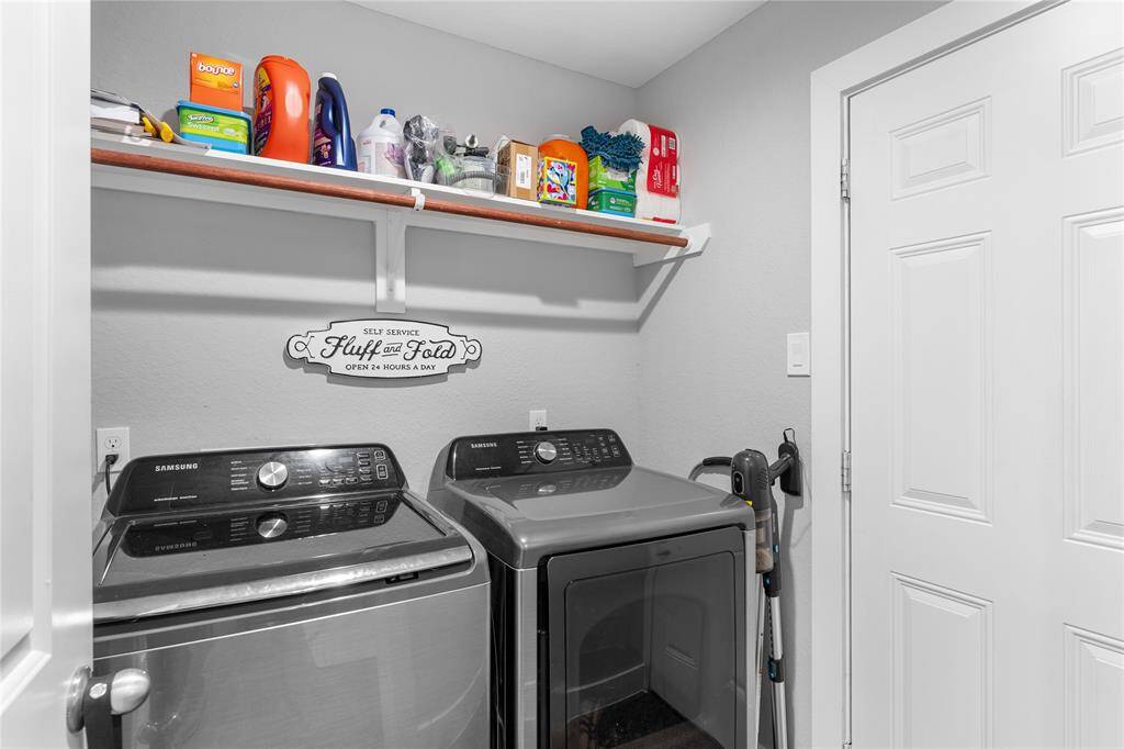 Laundry room w/ access to backyard.