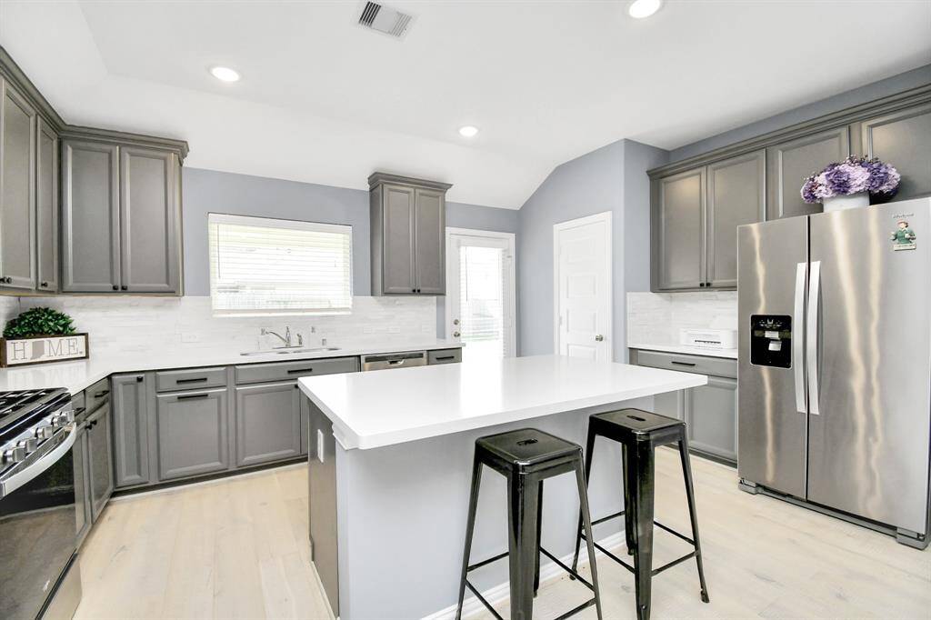 The abundant cabinetry offers plenty of storage for all your essentials - and the exterior door conveniently opens to the covered patio at the rear of the home!